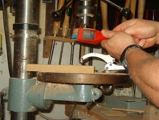 cleaning the assembly on the drill press