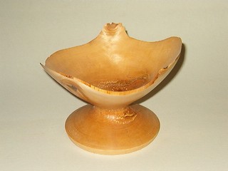 a footed bowl in yellow birch