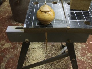 set it in a hole in a bench or jig 