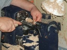 	use the parting tool in the right hand to make gentle cuts and fit the ferrule over the tenon. 	